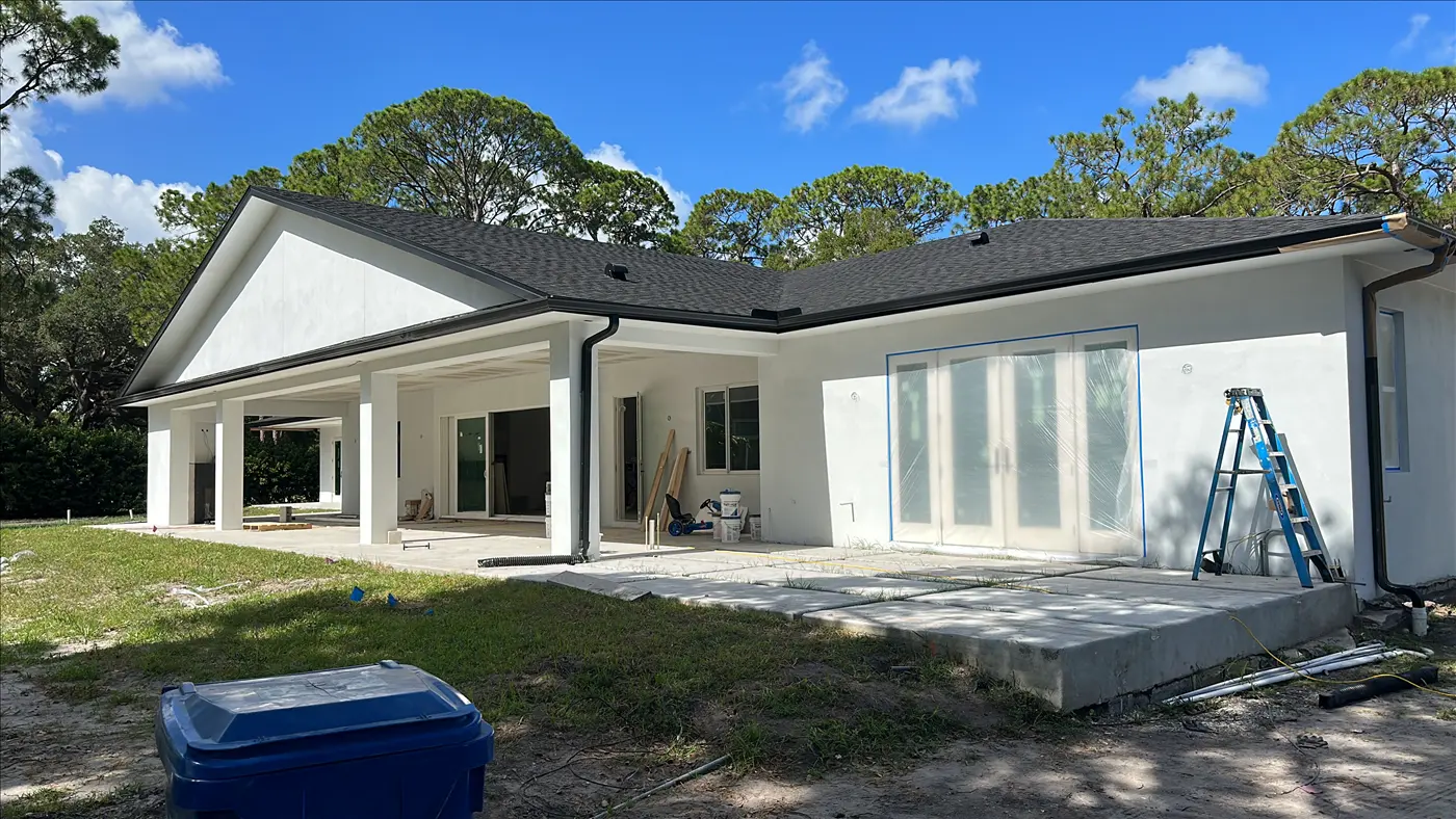 Single-story white home with a covered back porch and freshly painted exterior