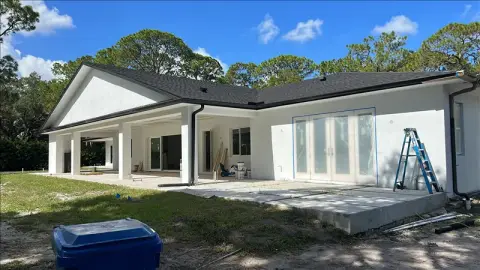 Single-story white home with a covered back porch and freshly painted exterior